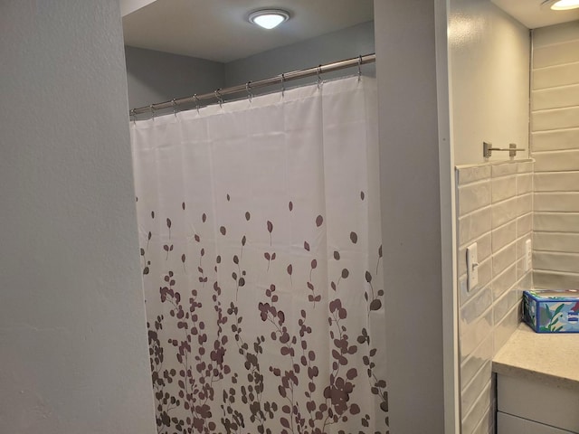 53 N Walnut St, Manteno, IL 60950 - bathroom with a shower with shower curtain, vanity, and decorative backsplash