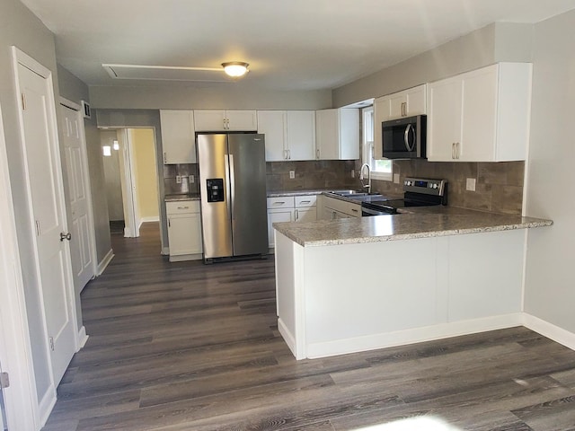 53 N Walnut St, Manteno, IL 60950 - kitchen with appliances with stainless steel finishes, a sink, dark wood-style flooring, and backsplash