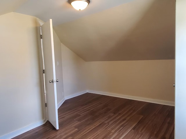 53 N Walnut St, Manteno, IL 60950 - additional living space with dark wood-style flooring, vaulted ceiling, and baseboards
