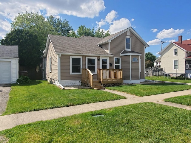 53 N Walnut St, Manteno, IL 60950 - view of front of property featuring a front yard, roof with shingles, and a deck