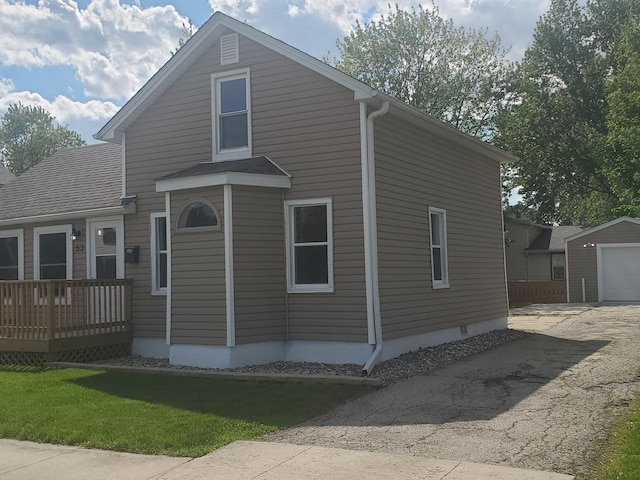 53 N Walnut St, Manteno, IL 60950 - view of front of property with asphalt driveway, an outbuilding, a detached garage, and a front yard
