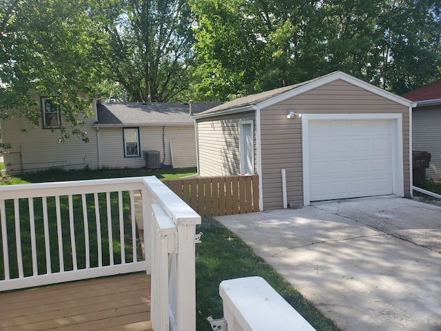 53 N Walnut St, Manteno, IL 60950 - view of front of property featuring an outbuilding, concrete driveway, central AC, a garage, and a shingled roof