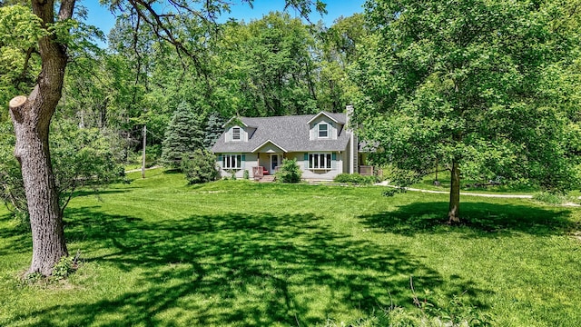 2655 N 3853rd Rd, Sheridan, IL 60551 - cape cod-style house featuring a chimney, a front lawn, and a wooded view