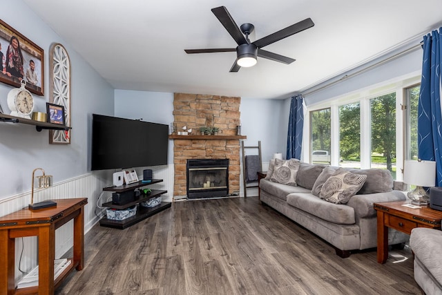 2655 N 3853rd Rd, Sheridan, IL 60551 - living room with a ceiling fan, wood finished floors, a stone fireplace, and wainscoting