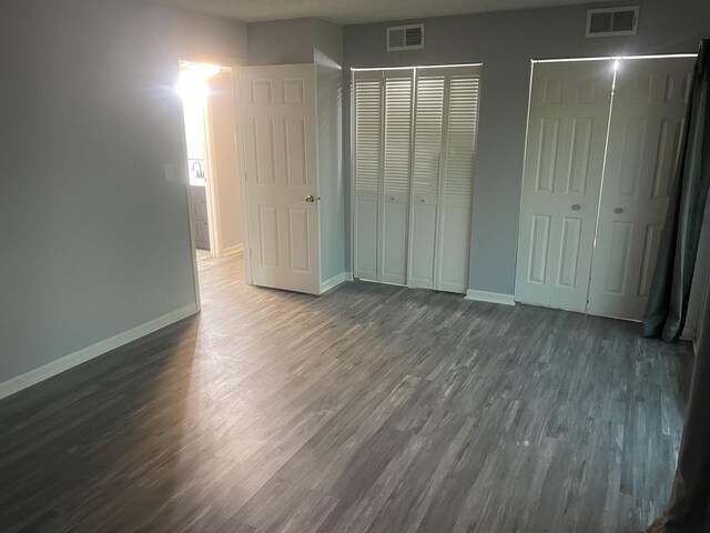 1616 Richmond Cir Unit 101, Joliet, IL 60435 - unfurnished bedroom with wood finished floors and baseboards