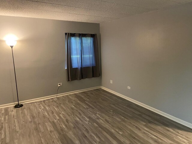 1616 Richmond Cir Unit 101, Joliet, IL 60435 - unfurnished room featuring dark wood-style flooring, baseboards, and a textured ceiling