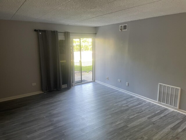 1616 Richmond Cir Unit 101, Joliet, IL 60435 - spare room featuring dark wood finished floors, baseboards, and a textured ceiling