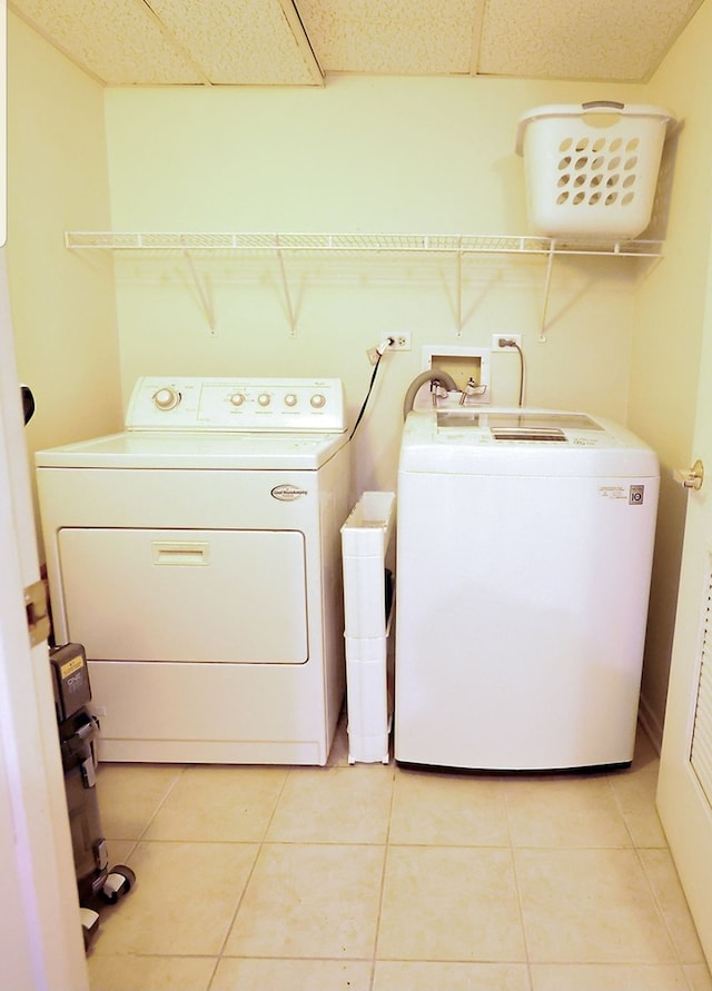 910 S Michigan Ave Unit 1805, Chicago, IL 60605 - washroom with separate washer and dryer and light tile patterned floors