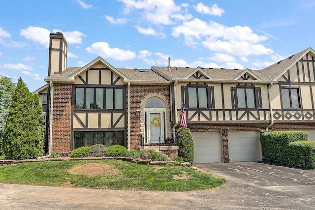 9254 Windsor Pkwy, Tinley Park, IL 60487 - view of front of property featuring a chimney, stucco siding, a garage, and brick siding