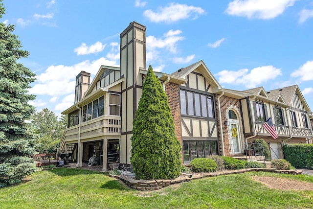 9254 Windsor Pkwy, Tinley Park, IL 60487 - exterior space with a chimney, brick siding, a front lawn, stucco siding, and a garage