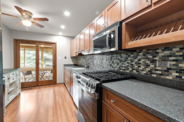 9254 Windsor Pkwy, Tinley Park, IL 60487 - kitchen with stainless steel appliances, a sink, dark countertops, a ceiling fan, and backsplash