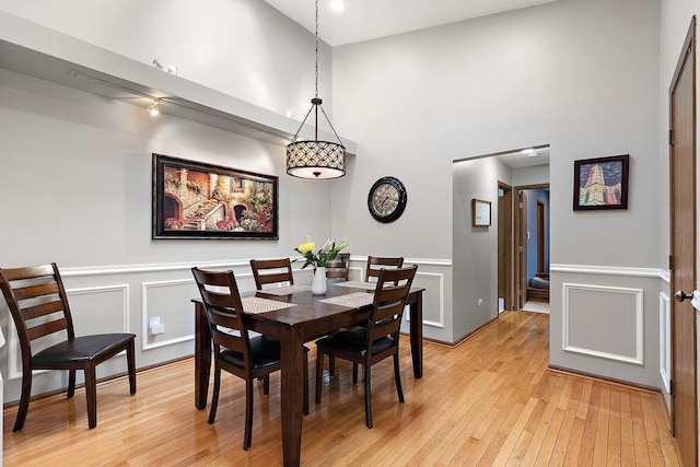 9254 Windsor Pkwy, Tinley Park, IL 60487 - dining room with light wood-style flooring, a decorative wall, a wainscoted wall, and a towering ceiling
