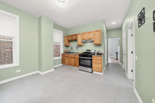5635 S May St, Chicago, IL 60621 - kitchen with stainless steel gas range, under cabinet range hood, and baseboards