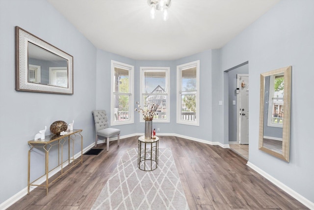 5635 S May St, Chicago, IL 60621 - living area featuring plenty of natural light, wood finished floors, and baseboards