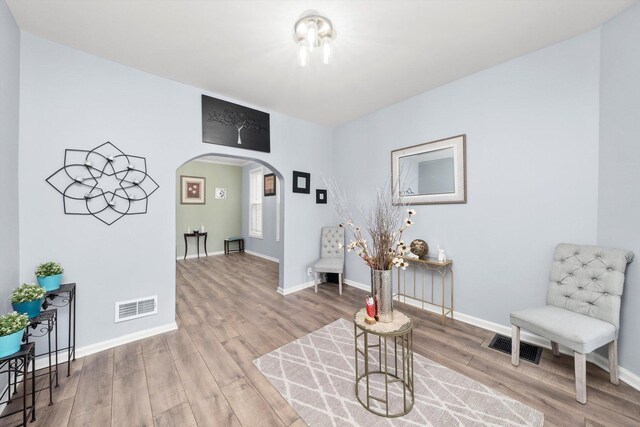 5635 S May St, Chicago, IL 60621 - living area with arched walkways, wood finished floors, and baseboards