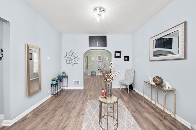 5635 S May St, Chicago, IL 60621 - sitting room featuring arched walkways, wood finished floors, and baseboards