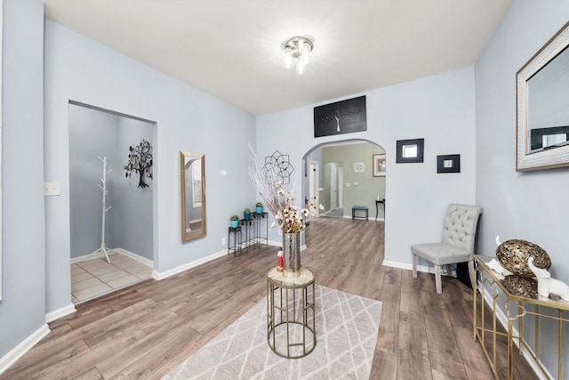 5635 S May St, Chicago, IL 60621 - sitting room featuring arched walkways, wood finished floors, and baseboards