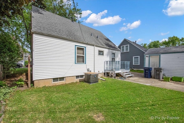 510 S Alfred Ave, Elgin, IL 60123 - back of house with a yard, roof with shingles, and central air condition unit