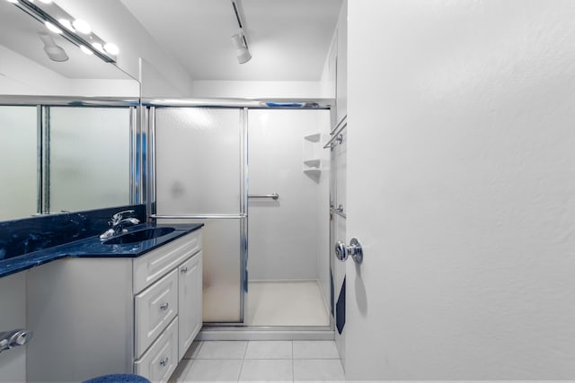 247 E Chestnut St Unit 1102, Chicago, IL 60611 - bathroom featuring a shower stall, vanity, and tile patterned floors