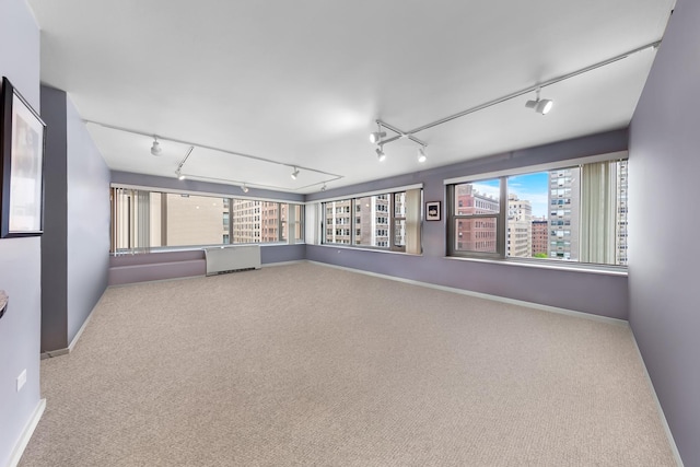 247 E Chestnut St Unit 1102, Chicago, IL 60611 - carpeted empty room featuring track lighting and baseboards