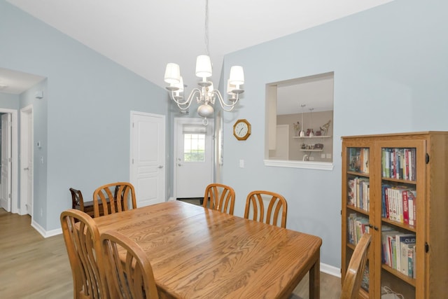 646 S Curran Rd, Round Lake, IL 60073 - dining space featuring a chandelier, wood finished floors, and baseboards