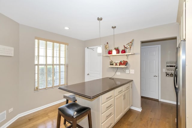 646 S Curran Rd, Round Lake, IL 60073 - kitchen featuring freestanding refrigerator, dark countertops, light wood-style floors, white cabinets, and recessed lighting