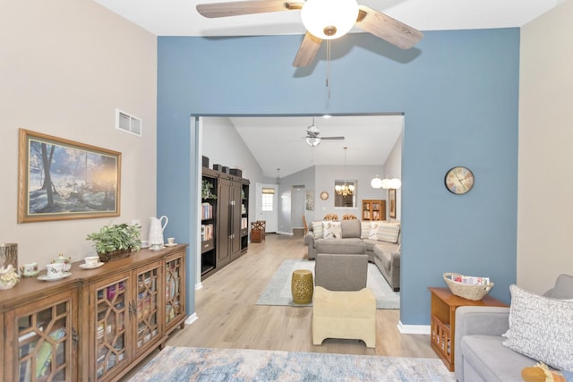 646 S Curran Rd, Round Lake, IL 60073 - living area featuring vaulted ceiling, a ceiling fan, light wood-type flooring, a chandelier, and baseboards