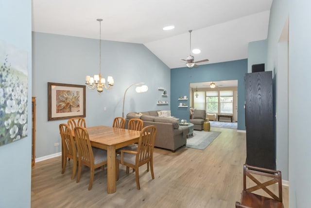 646 S Curran Rd, Round Lake, IL 60073 - dining space with ceiling fan, light wood-style flooring, vaulted ceiling, a chandelier, and baseboards