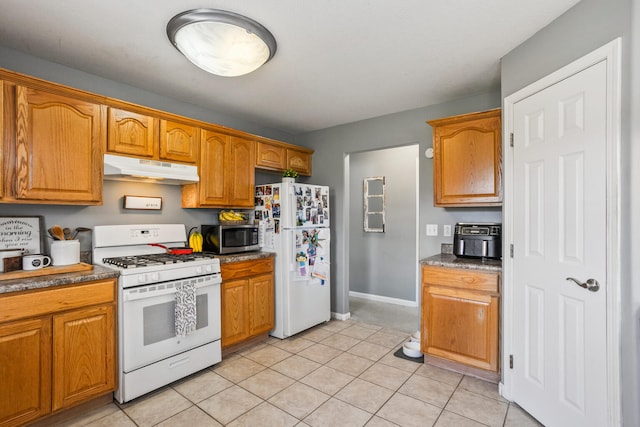 713 Sedgegrass Dr, Champaign, IL 61822 - kitchen featuring white appliances, under cabinet range hood, brown cabinetry, and light tile patterned floors