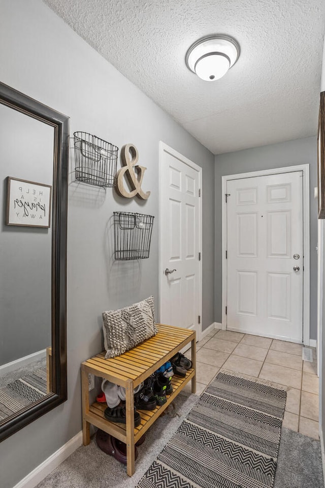 713 Sedgegrass Dr, Champaign, IL 61822 - mudroom with a textured ceiling and light tile patterned floors