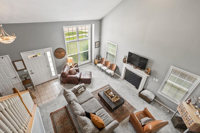 713 Sedgegrass Dr, Champaign, IL 61822 - carpeted living area with high vaulted ceiling and tile patterned flooring