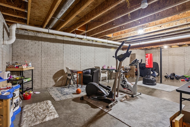713 Sedgegrass Dr, Champaign, IL 61822 - workout room featuring brick wall