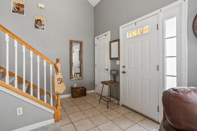 713 Sedgegrass Dr, Champaign, IL 61822 - entrance foyer with light tile patterned floors, stairway, and a towering ceiling