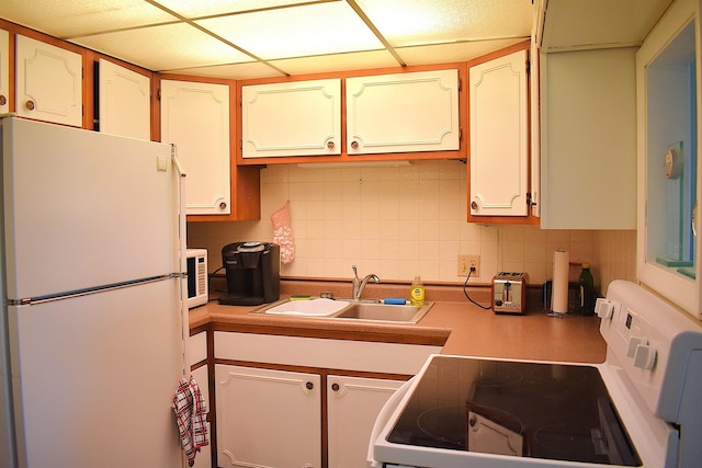 2900 Maple Ave Unit 10E, Downers Grove, IL 60515 - kitchen featuring white appliances, a sink, decorative backsplash, light countertops, and a paneled ceiling