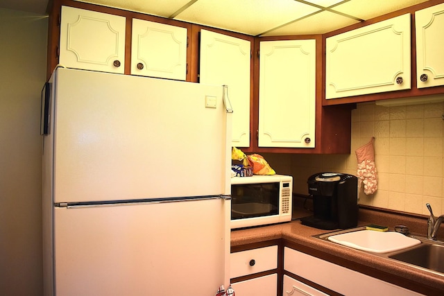 2900 Maple Ave Unit 10E, Downers Grove, IL 60515 - kitchen featuring white appliances, a sink, decorative backsplash, and dark countertops