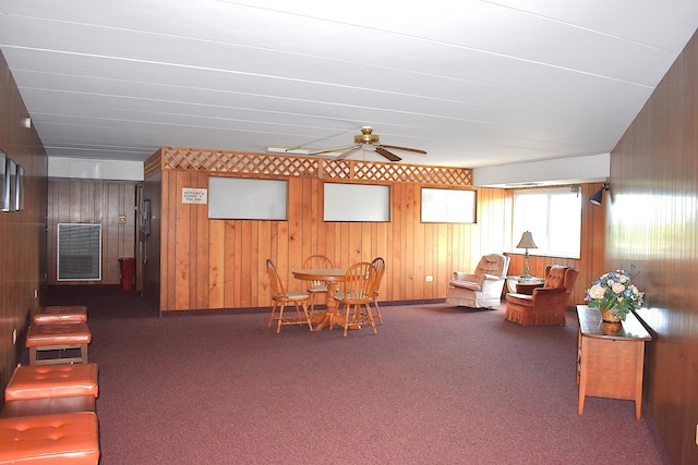 2900 Maple Ave Unit 10E, Downers Grove, IL 60515 - living room with carpet flooring, a ceiling fan, and wooden walls