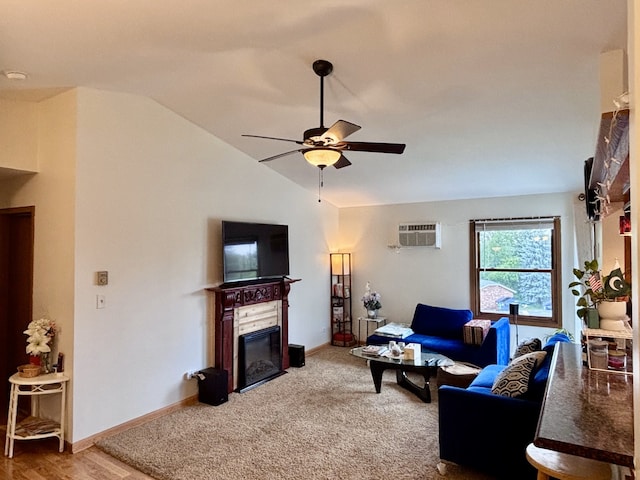 4316 W Shamrock Ln Unit 3C, Mchenry, IL 60050 - living area featuring a ceiling fan, vaulted ceiling, a wall unit AC, a glass covered fireplace, and carpet flooring