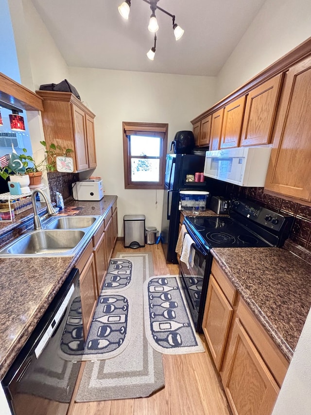 4316 W Shamrock Ln Unit 3C, Mchenry, IL 60050 - kitchen with black appliances, a sink, light wood-type flooring, dark countertops, and brown cabinets