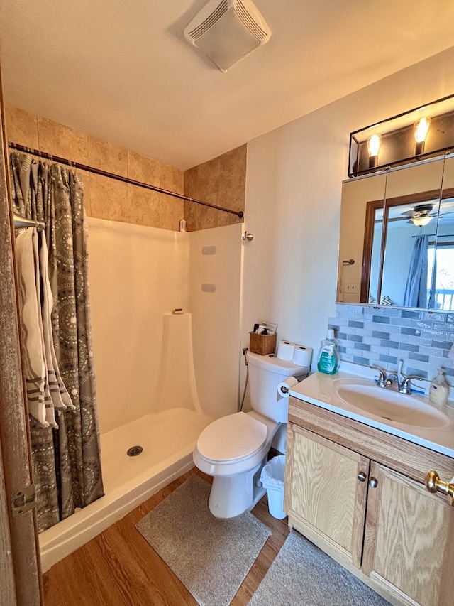 4316 W Shamrock Ln Unit 3C, Mchenry, IL 60050 - bathroom featuring toilet, wood finished floors, a shower with shower curtain, vanity, and decorative backsplash