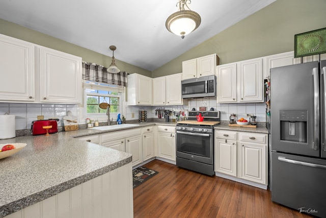 20005 S Mallory Dr, Frankfort, IL 60423 - kitchen featuring stainless steel appliances, a sink, vaulted ceiling, decorative backsplash, and dark wood-type flooring