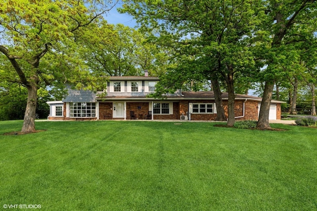 43389 N Oakcrest Ln N, Zion, IL 60099 - traditional-style house featuring a front yard, an attached garage, brick siding, and a chimney