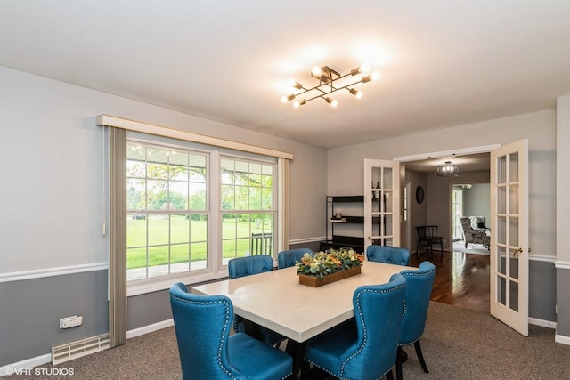 43389 N Oakcrest Ln N, Zion, IL 60099 - carpeted dining area featuring a chandelier, healthy amount of natural light, and baseboards