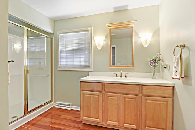 43389 N Oakcrest Ln N, Zion, IL 60099 - bathroom featuring vanity, a stall shower, wood finished floors, and baseboards
