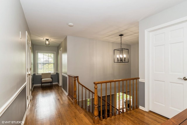 43389 N Oakcrest Ln N, Zion, IL 60099 - hall with an upstairs landing, wood finished floors, a chandelier, and baseboards