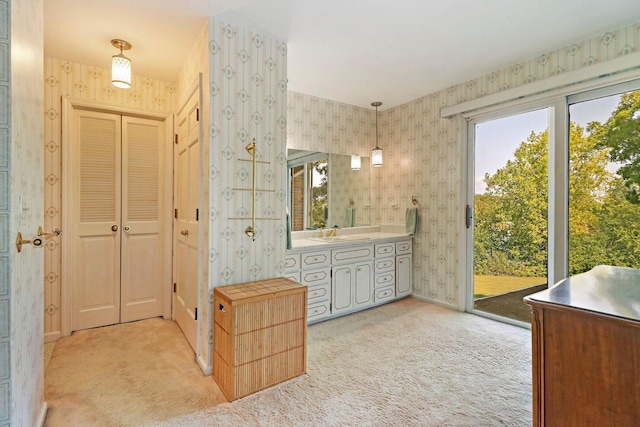 43389 N Oakcrest Ln N, Zion, IL 60099 - bathroom with wallpapered walls, vanity, a closet, and baseboards