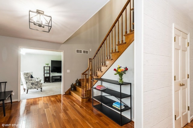 43389 N Oakcrest Ln N, Zion, IL 60099 - stairway with hardwood / wood-style flooring, a chandelier, and baseboards