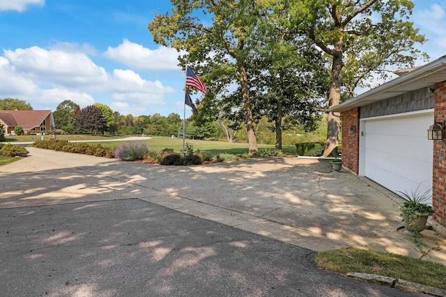 43389 N Oakcrest Ln N, Zion, IL 60099 - view of patio with a garage and driveway