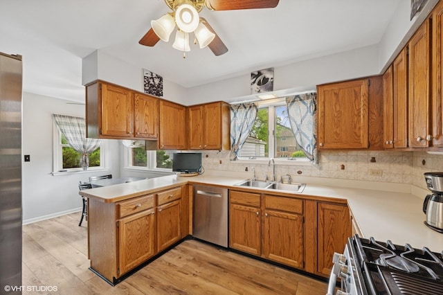 211 W Kenilworth Ave, Prospect Heights, IL 60070 - kitchen with a sink, stainless steel dishwasher, a peninsula, and light countertops