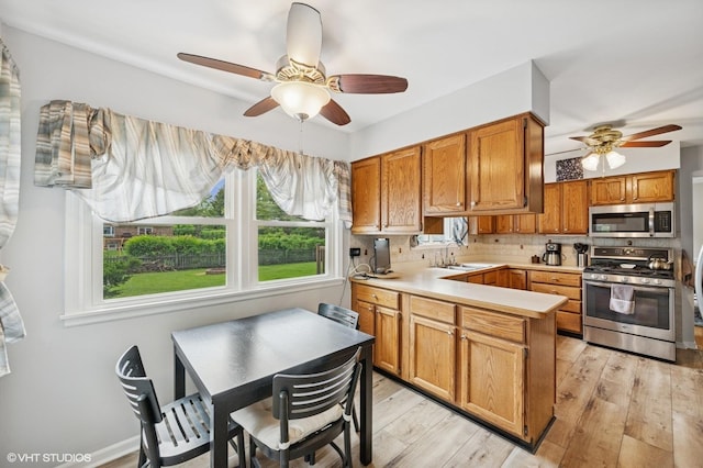 211 W Kenilworth Ave, Prospect Heights, IL 60070 - kitchen featuring appliances with stainless steel finishes, a ceiling fan, a peninsula, and light countertops