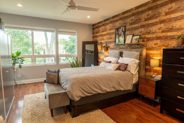 1009 Lathrop Ave, Forest Park, IL 60130 - bedroom with wooden walls, an accent wall, recessed lighting, baseboards, and wood finished floors